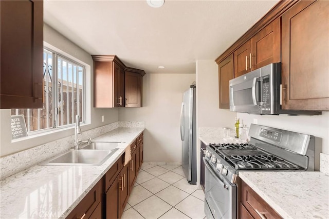 1571 S Reservoir St Unit C, Pomona, CA 91766 - kitchen with appliances with stainless steel finishes, light tile patterned floors, light stone countertops, and brown cabinets