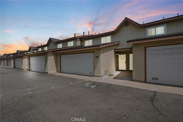 1571 S Reservoir St Unit C, Pomona, CA 91766 - view of property with community garages and stucco siding