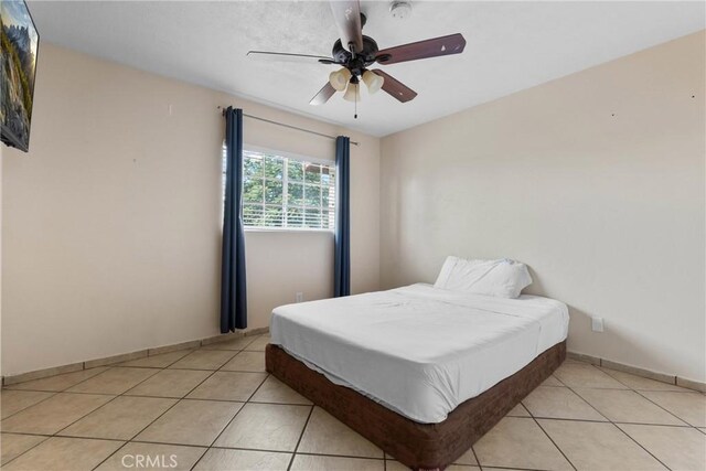 1571 S Reservoir St Unit C, Pomona, CA 91766 - bedroom featuring light tile patterned floors and a ceiling fan
