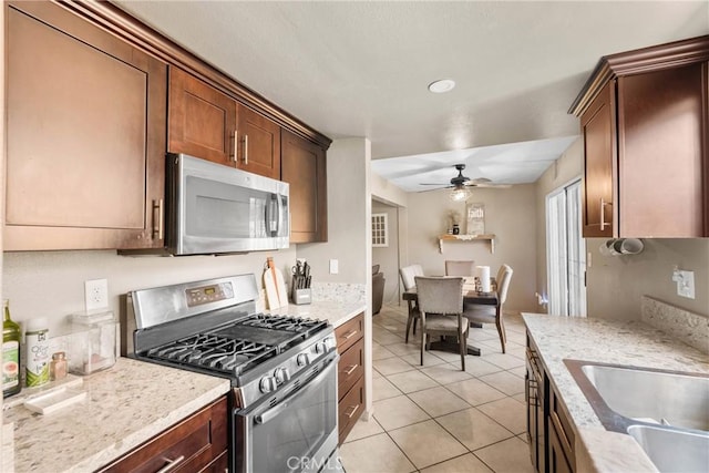 1571 S Reservoir St Unit C, Pomona, CA 91766 - kitchen featuring appliances with stainless steel finishes, ceiling fan, light tile patterned flooring, and light stone counters