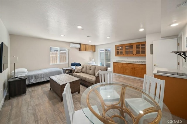 1565 Strand Way, Oceano, CA 93445 - living room featuring a wall mounted AC, light wood finished floors, and recessed lighting