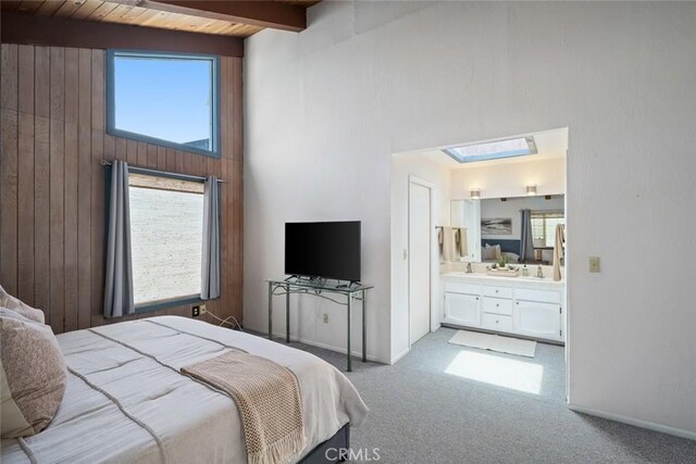 1565 Strand Way, Oceano, CA 93445 - bedroom with light carpet, multiple windows, wooden walls, a high ceiling, and connected bathroom