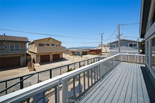 1565 Strand Way, Oceano, CA 93445 - deck with an attached garage, driveway, and a residential view