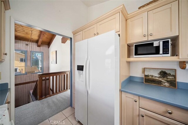 1565 Strand Way, Oceano, CA 93445 - kitchen with white fridge with ice dispenser, stainless steel microwave, light tile patterned floors, a wooden ceiling with exposed beams, and wood walls