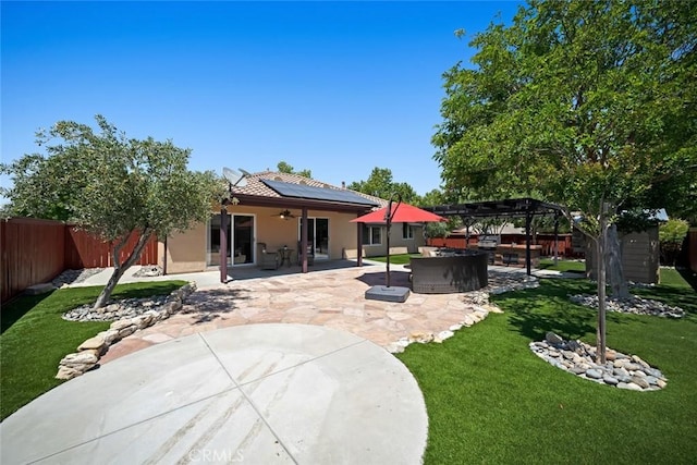 2636 Vineyard Cir, Paso Robles, CA 93446 - back of property with ceiling fan, a hot tub, a fenced backyard, and a patio