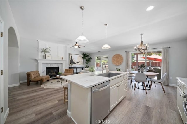 2636 Vineyard Cir, Paso Robles, CA 93446 - kitchen featuring stainless steel dishwasher, wood finished floors, light countertops, ceiling fan, and a premium fireplace