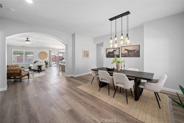 2636 Vineyard Cir, Paso Robles, CA 93446 - dining area with arched walkways, wood finished floors, a chandelier, and ceiling fan
