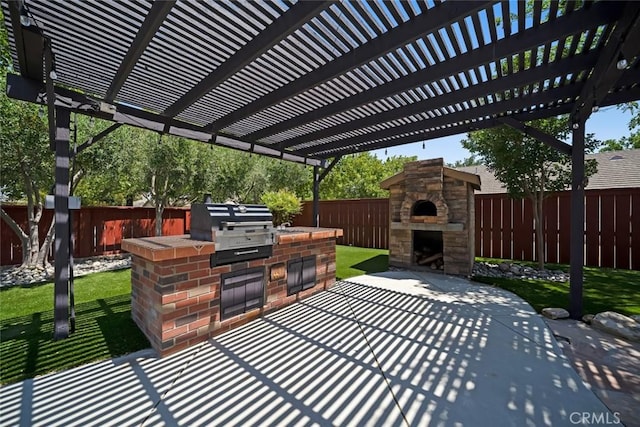 2636 Vineyard Cir, Paso Robles, CA 93446 - fenced backyard featuring an outdoor stone fireplace, an outdoor kitchen, a patio, and a pergola
