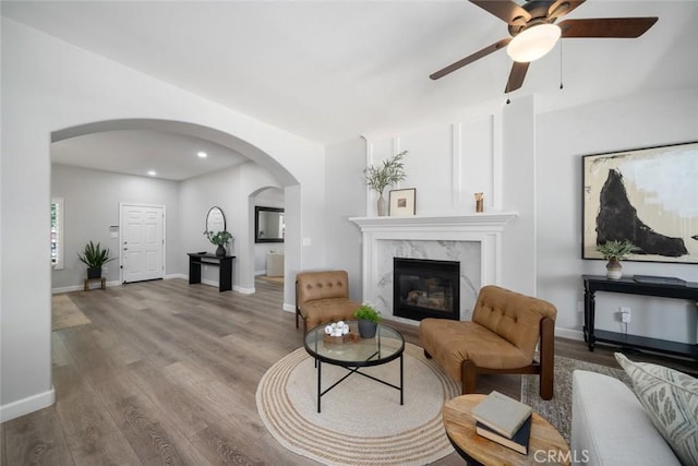 2636 Vineyard Cir, Paso Robles, CA 93446 - living area featuring arched walkways, a ceiling fan, wood finished floors, a premium fireplace, and recessed lighting
