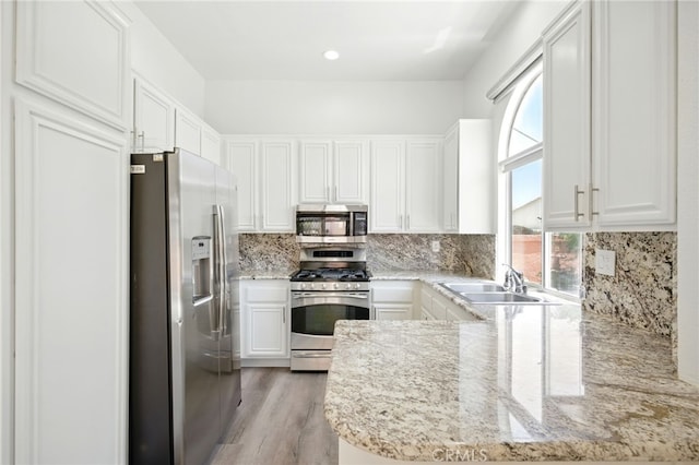 477 S Maidstone St, Banning, CA 92220 - kitchen with stainless steel appliances, healthy amount of natural light, and white cabinetry