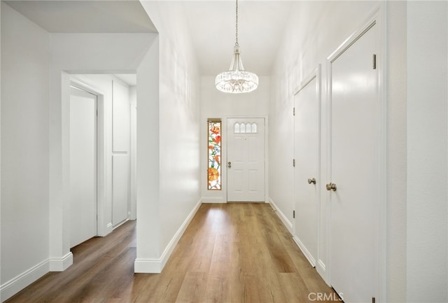 477 S Maidstone St, Banning, CA 92220 - foyer with light wood-type flooring and a chandelier