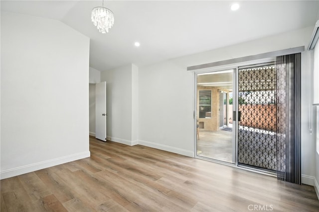 477 S Maidstone St, Banning, CA 92220 - unfurnished room featuring lofted ceiling, wood finished floors, a chandelier, and recessed lighting