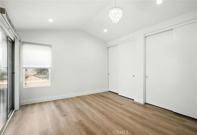 477 S Maidstone St, Banning, CA 92220 - unfurnished bedroom with multiple closets, vaulted ceiling, wood finished floors, recessed lighting, and a chandelier