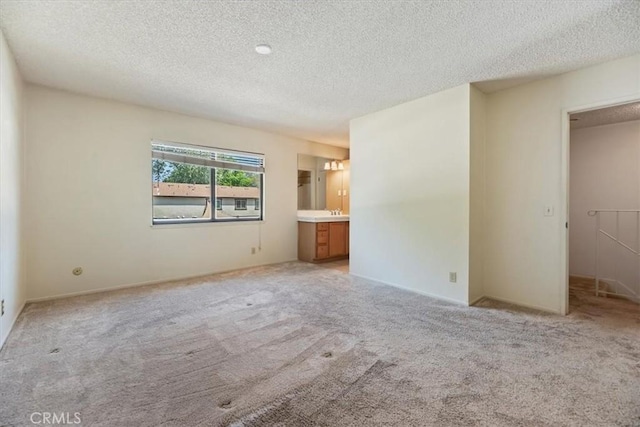 2829 Irving St, Riverside, CA 92504 - unfurnished bedroom featuring a textured ceiling, light carpet, and connected bathroom