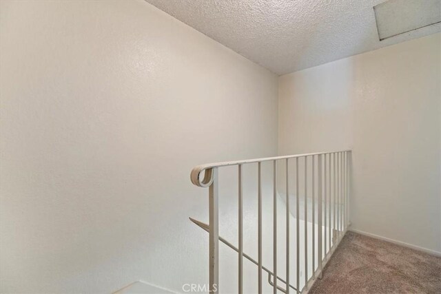 2829 Irving St, Riverside, CA 92504 - staircase with a textured ceiling, carpet flooring, and attic access