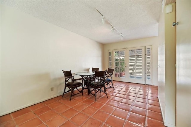 2829 Irving St, Riverside, CA 92504 - dining space featuring rail lighting, a textured ceiling, and tile patterned floors