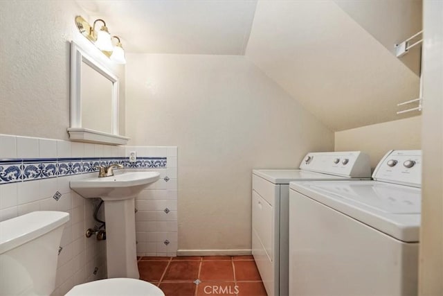 2829 Irving St, Riverside, CA 92504 - bathroom with washer and clothes dryer, tile patterned floors, tile walls, and vaulted ceiling