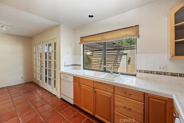2829 Irving St, Riverside, CA 92504 - kitchen featuring white dishwasher, decorative backsplash, healthy amount of natural light, and brown cabinets