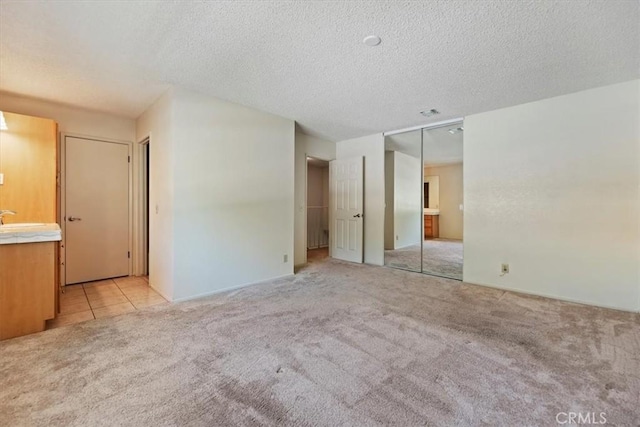 2829 Irving St, Riverside, CA 92504 - unfurnished bedroom with carpet floors, a textured ceiling, a closet, and ensuite bathroom