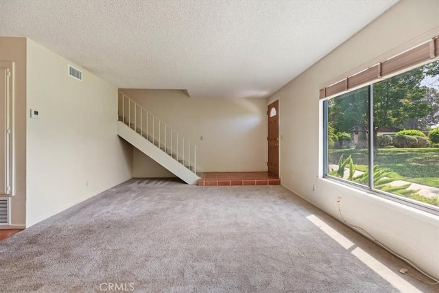 2829 Irving St, Riverside, CA 92504 - unfurnished living room with carpet floors, a textured ceiling, and stairs