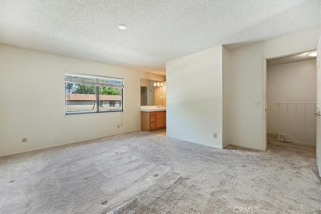 2829 Irving St, Riverside, CA 92504 - unfurnished bedroom featuring a textured ceiling and light carpet