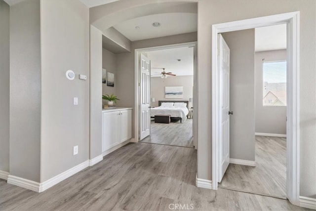 420 Deodar St, Redlands, CA 92374 - hallway with light wood-style flooring and arched walkways