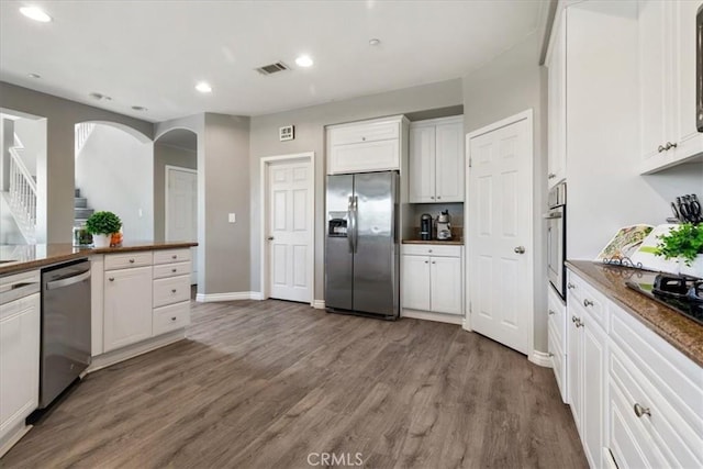 420 Deodar St, Redlands, CA 92374 - kitchen with appliances with stainless steel finishes, white cabinetry, wood finished floors, recessed lighting, and arched walkways