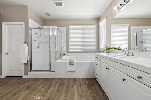 420 Deodar St, Redlands, CA 92374 - bathroom featuring vanity, a garden tub, wood finished floors, and a stall shower