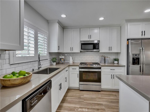 2867 Turnbull St, Oceanside, CA 92054 - kitchen with stainless steel appliances, white cabinetry, tasteful backsplash, recessed lighting, and light countertops