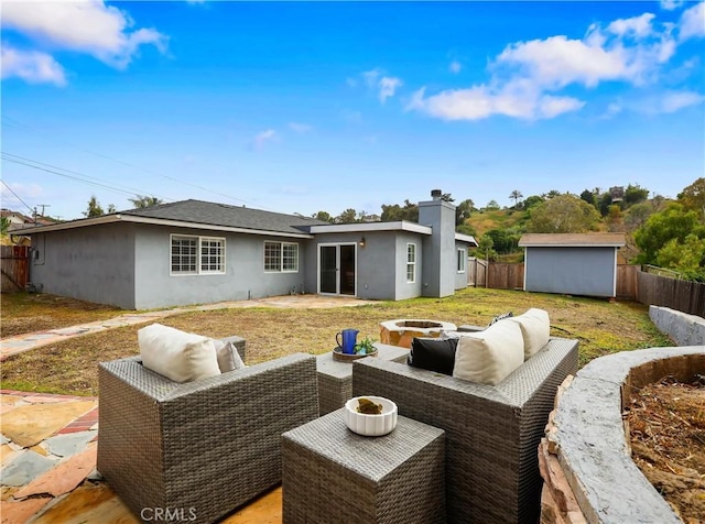 2867 Turnbull St, Oceanside, CA 92054 - back of property with stucco siding, a fenced backyard, a patio area, and a storage unit