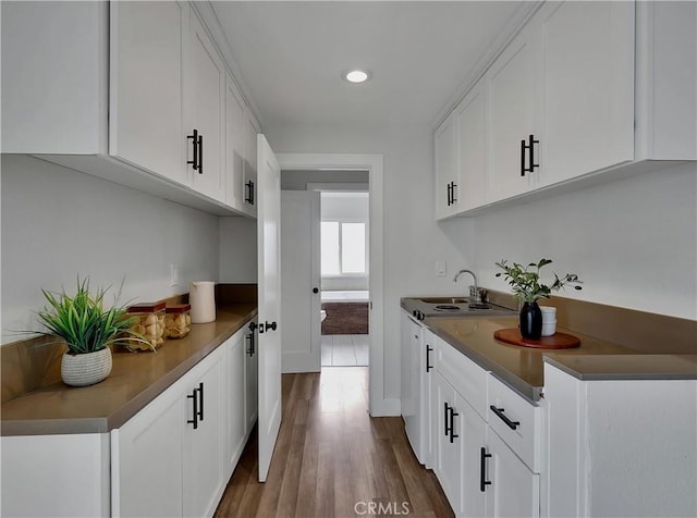 2867 Turnbull St, Oceanside, CA 92054 - kitchen with dark countertops, white cabinets, dark wood-style floors, and recessed lighting