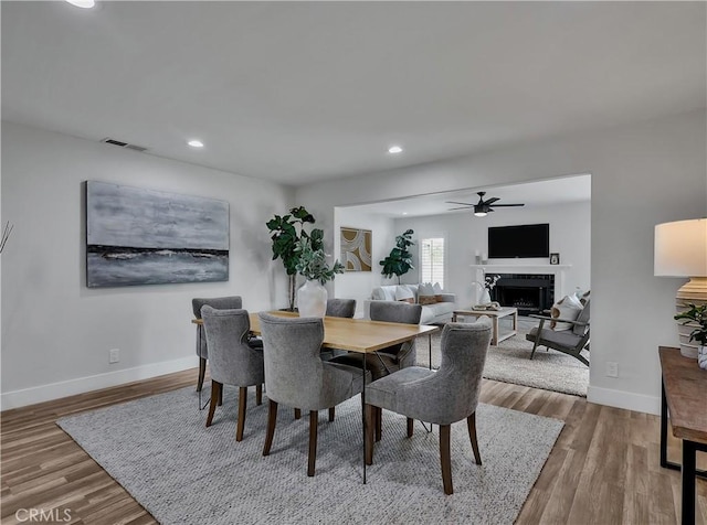 2867 Turnbull St, Oceanside, CA 92054 - dining area with a ceiling fan, a fireplace, wood finished floors, and recessed lighting