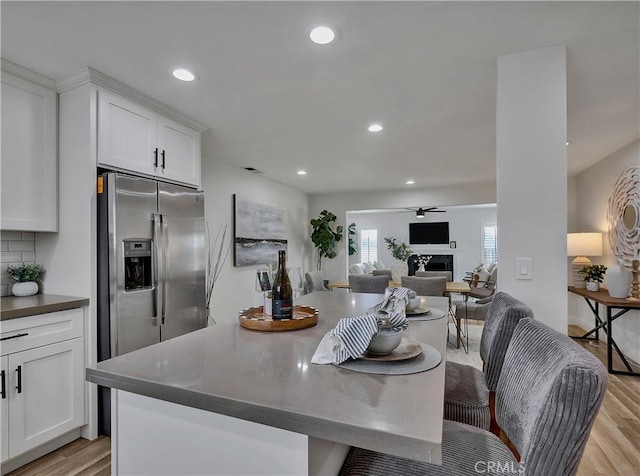 2867 Turnbull St, Oceanside, CA 92054 - kitchen with stainless steel fridge, light wood-type flooring, white cabinets, recessed lighting, and open floor plan