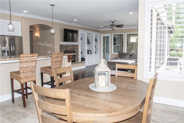 1671 Fairway Dr, Corona, CA 92883 - dining area featuring ceiling fan, arched walkways, crown molding, a stone fireplace, and recessed lighting