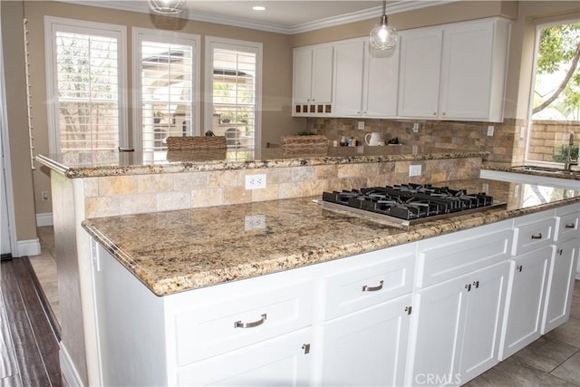 1671 Fairway Dr, Corona, CA 92883 - kitchen with gas stovetop, decorative backsplash, crown molding, light stone counters, and white cabinetry