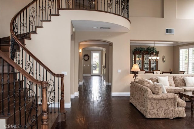 1671 Fairway Dr, Corona, CA 92883 - living room featuring arched walkways, wood finished floors, a chandelier, a towering ceiling, and stairs