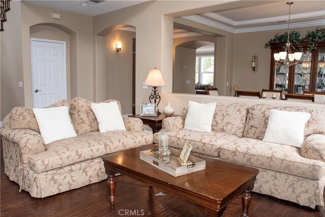 1671 Fairway Dr, Corona, CA 92883 - living room with arched walkways, a chandelier, dark wood-type flooring, and ornamental molding