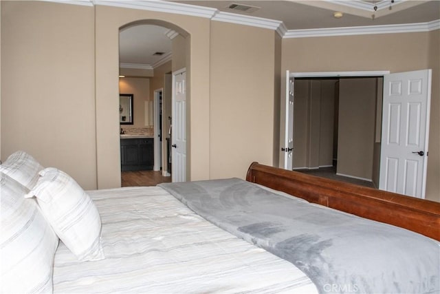 1671 Fairway Dr, Corona, CA 92883 - bedroom featuring crown molding, arched walkways, a closet, and connected bathroom