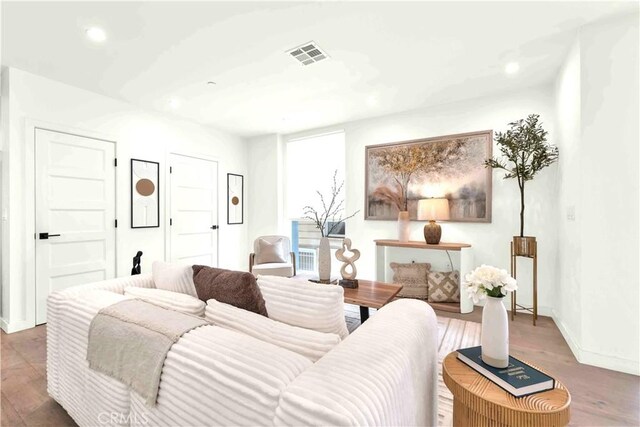 1131/2 N Manhattan Pl, Los Angeles, CA 90004 - living area featuring wood finished floors and recessed lighting