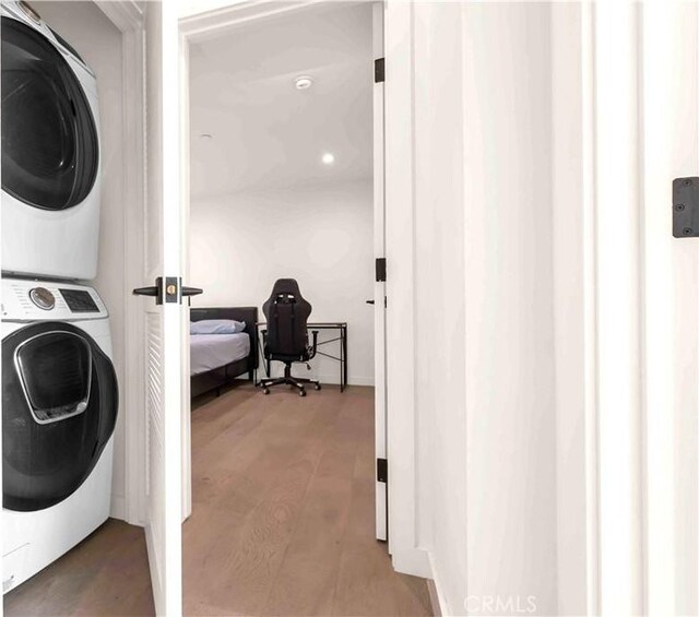 1131/2 N Manhattan Pl, Los Angeles, CA 90004 - laundry room featuring estacked washer and dryer and wood finished floors