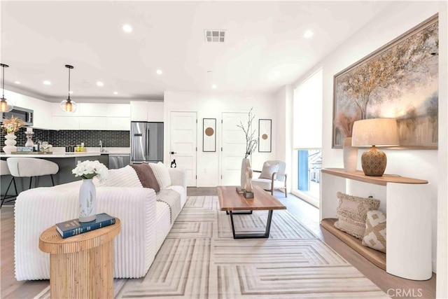 1131/2 N Manhattan Pl, Los Angeles, CA 90004 - living area with recessed lighting and light wood-type flooring