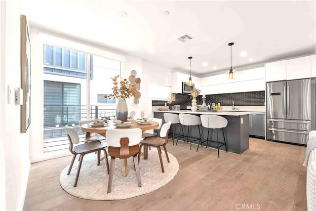 1131/2 N Manhattan Pl, Los Angeles, CA 90004 - dining space featuring light wood-type flooring and recessed lighting