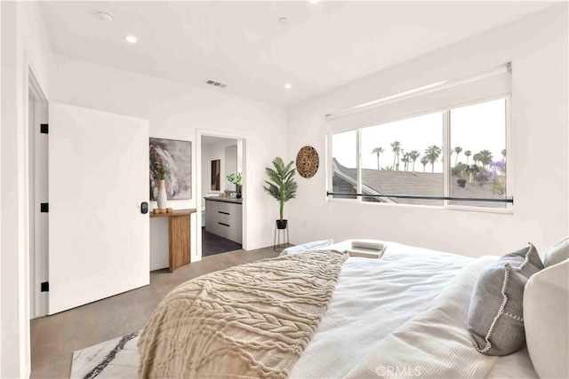 1131/2 N Manhattan Pl, Los Angeles, CA 90004 - bedroom with connected bathroom, recessed lighting, and finished concrete floors