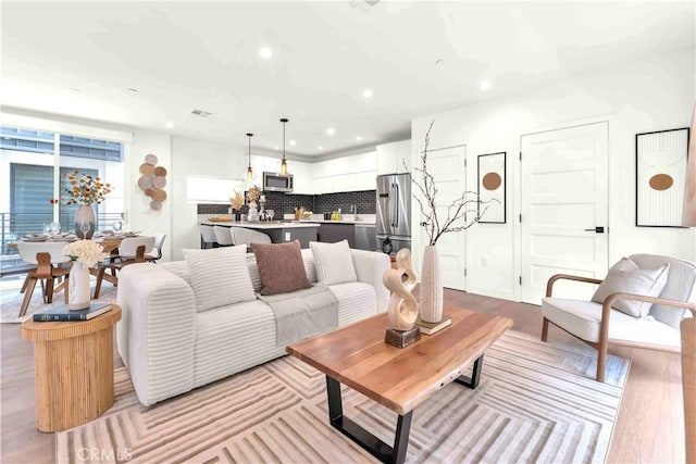 1131/2 N Manhattan Pl, Los Angeles, CA 90004 - living area featuring recessed lighting and light wood finished floors