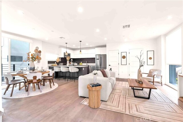 1131/2 N Manhattan Pl, Los Angeles, CA 90004 - living room featuring plenty of natural light, recessed lighting, and light wood-style flooring