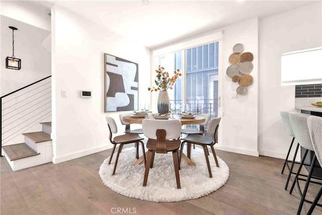1131/2 N Manhattan Pl, Los Angeles, CA 90004 - dining space with wood finished floors and stairway