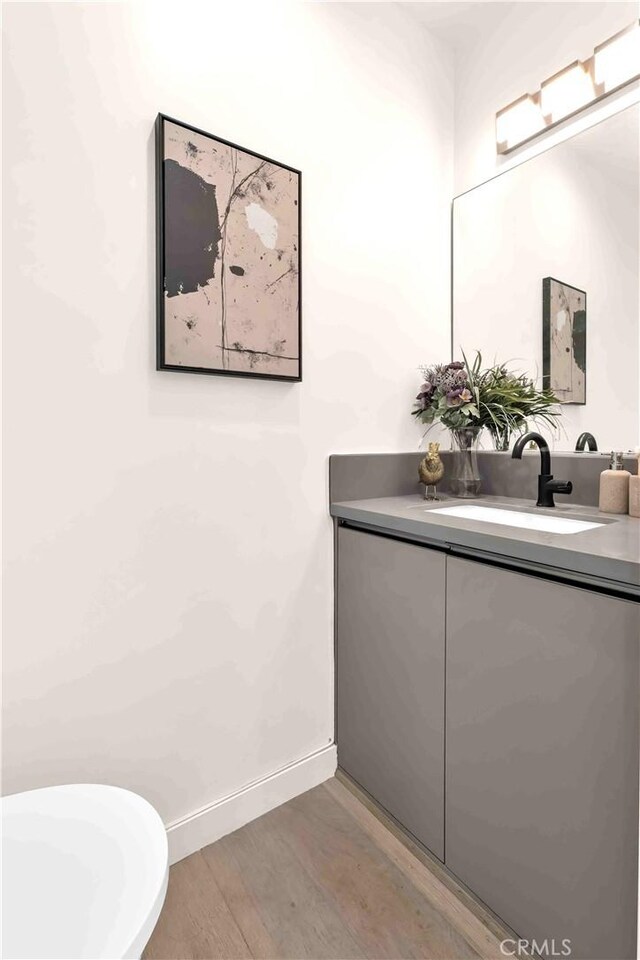 1131/2 N Manhattan Pl, Los Angeles, CA 90004 - bathroom with wood finished floors and vanity
