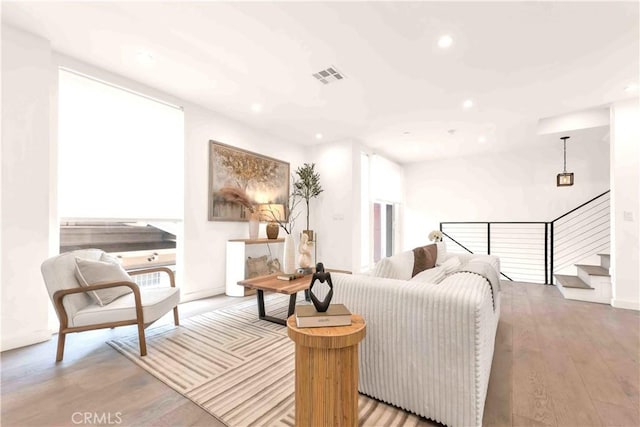1131/2 N Manhattan Pl, Los Angeles, CA 90004 - living room featuring recessed lighting, wood finished floors, and stairway