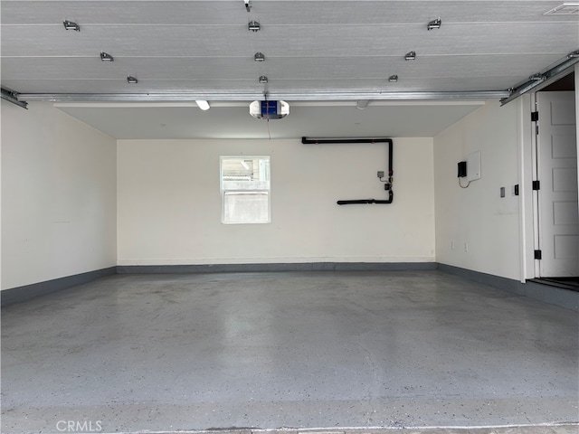 1131/2 N Manhattan Pl, Los Angeles, CA 90004 - garage featuring a garage door opener and baseboards
