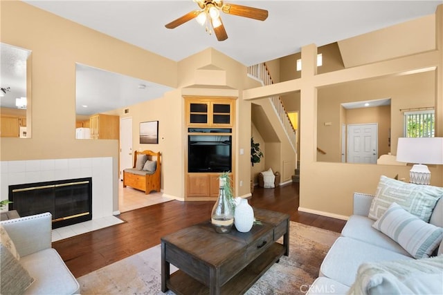 8 Chatri Cir, Lake Forest, CA 92610 - living area featuring ceiling fan, wood finished floors, stairway, and a tile fireplace